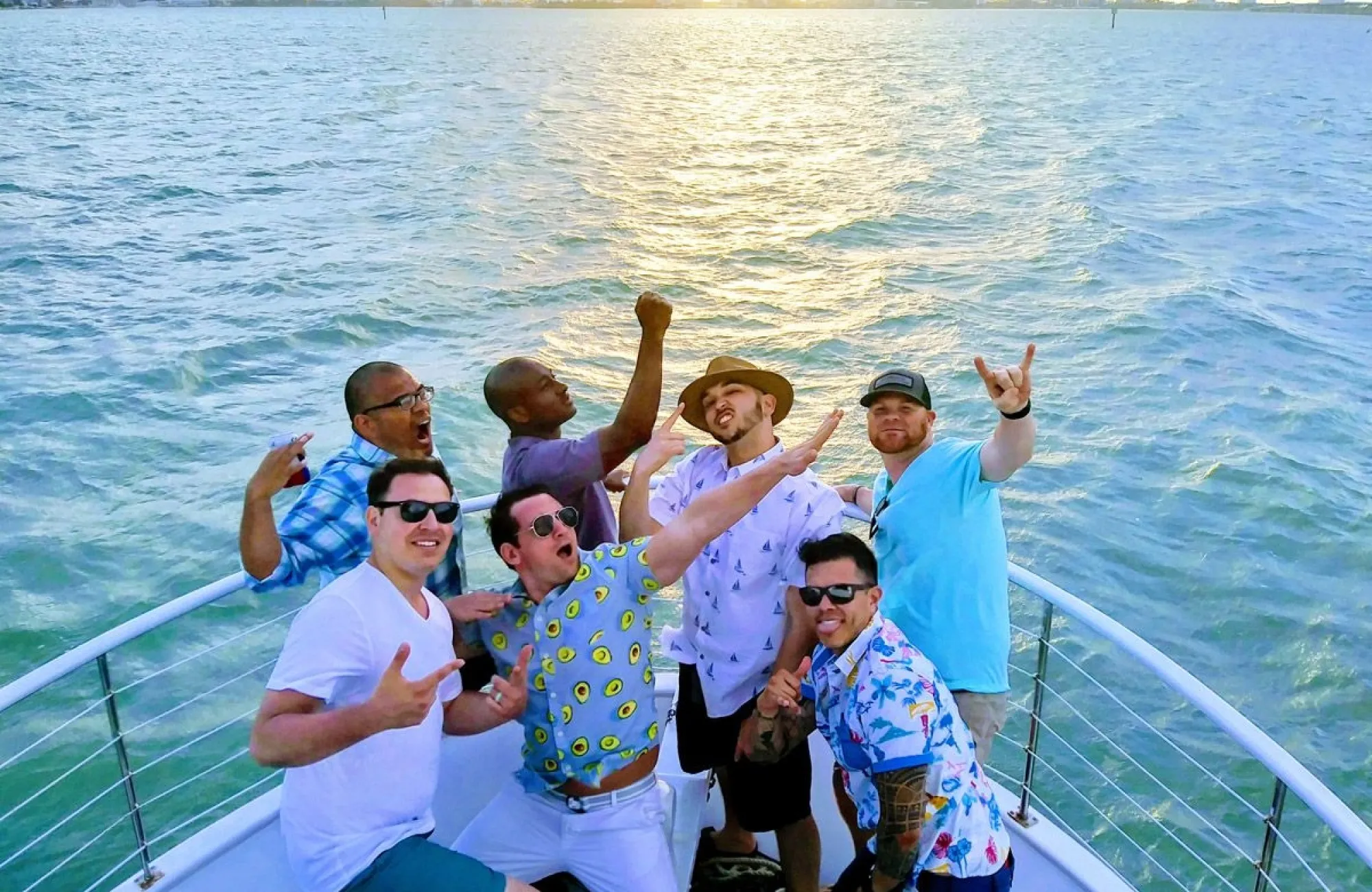 64c03e92-08d0-4041-a86c-afdc7b18975c Group of friends celebrating on a yacht during a Miami bachelor party