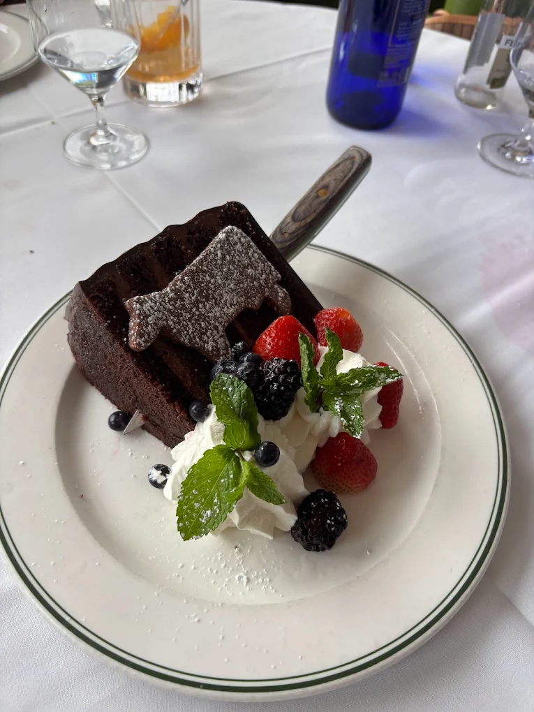 Slice of chocolate cake with berries and whipped cream at Smith & Wollensky