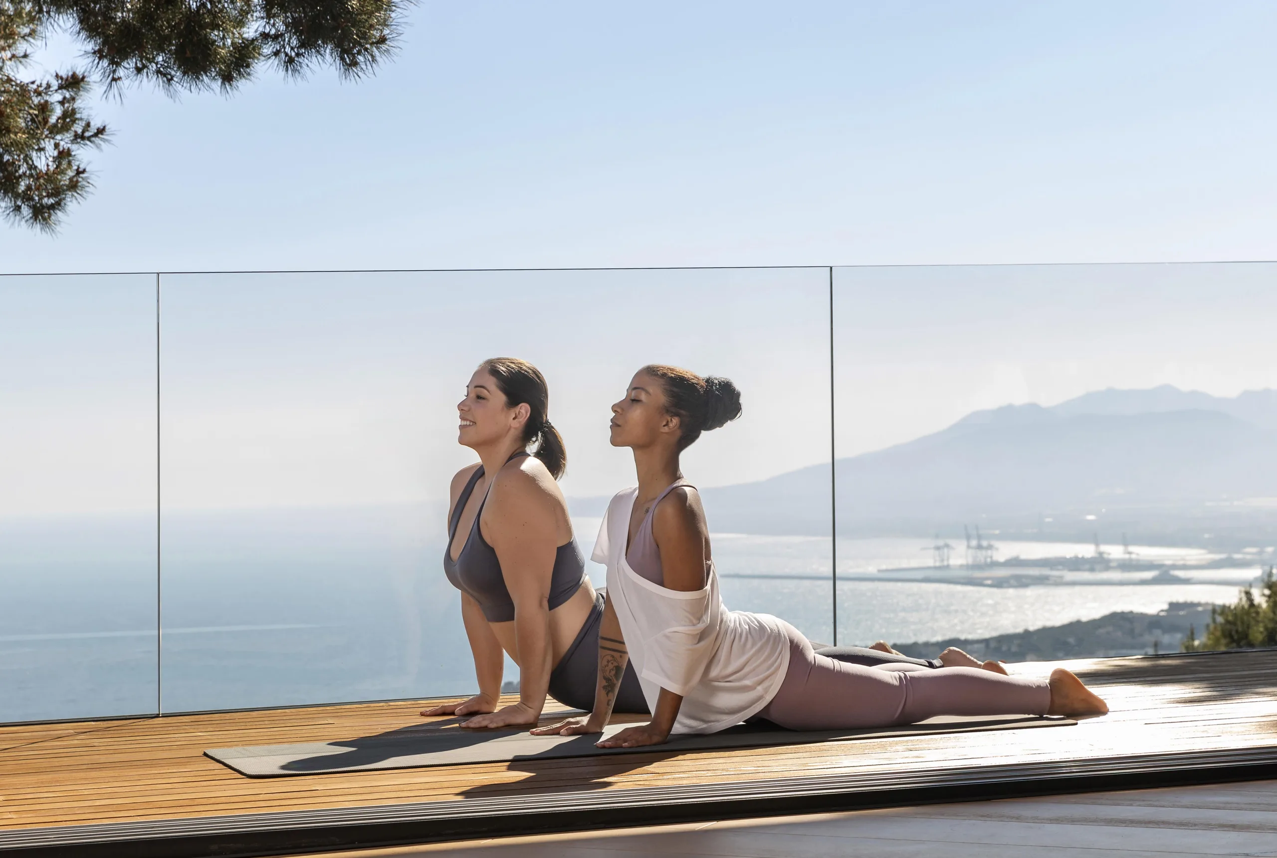Yoga Session Wellness retreat scene with two women in yoga session by the sea in Miami Beach