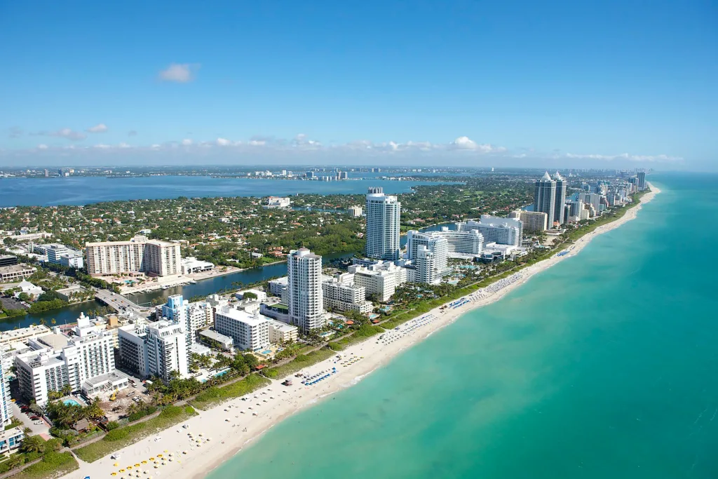 Aerial view of Miami Beach showing the coastline and city skyline, highlighting the beauty of Hidden Gems in Miami Beach.
