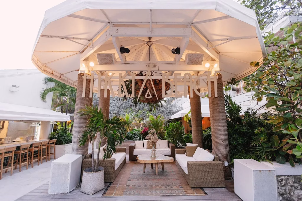 Open-air beachfront dining setup at Nikki Beach in Miami Beach