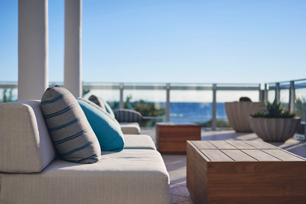 Outdoor terrace tables facing the beach at The Strand in Miami Beach
