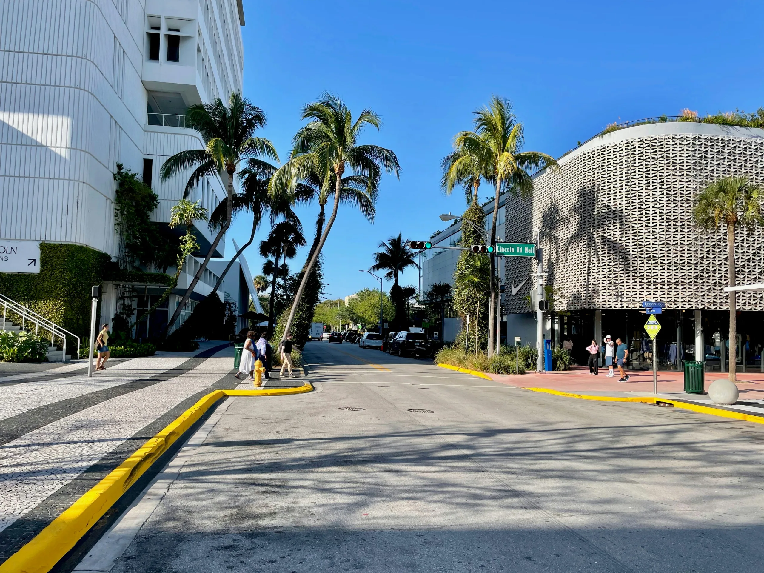 Lincoln Road sign in Miami Beach Street view of Lincoln Road Miami Beach with the Lincoln Road sign and palm trees.