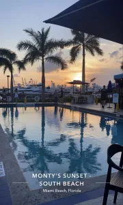 Poolside tables and the Miami Beach Marina at sunset at Monty's Sunset in Miami Beach.