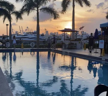 Poolside tables and the Miami Beach Marina at sunset at Monty's Sunset in Miami Beach.