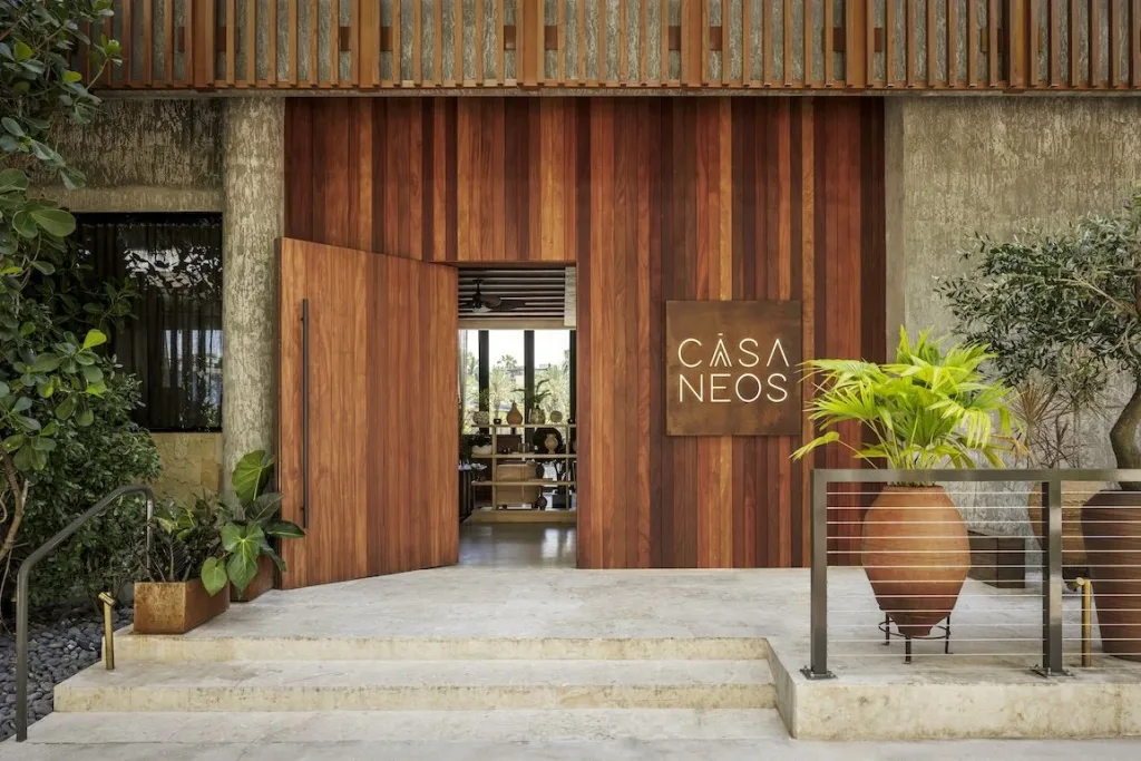 Casa Neos entrance with modern signage and inviting lighting
