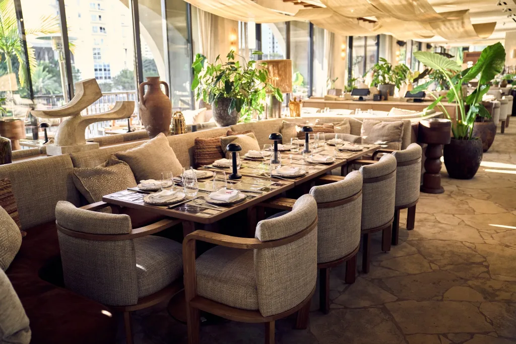 Casa Neos dinner table set with elegant plates, warm light, and a cozy upscale atmosphere