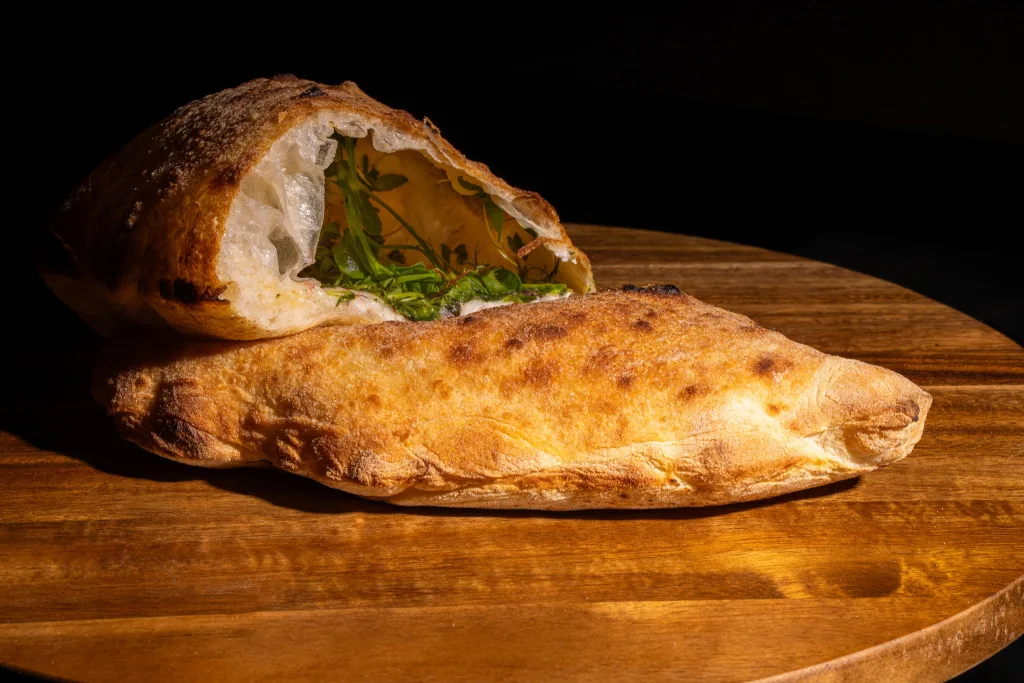 Traditional Italian calzone pizza, folded and baked to a golden finish