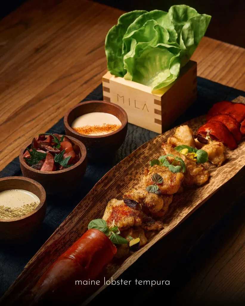 Romantic dinner at MILA Miami with shared plates, and a vibrant upscale atmosphere.