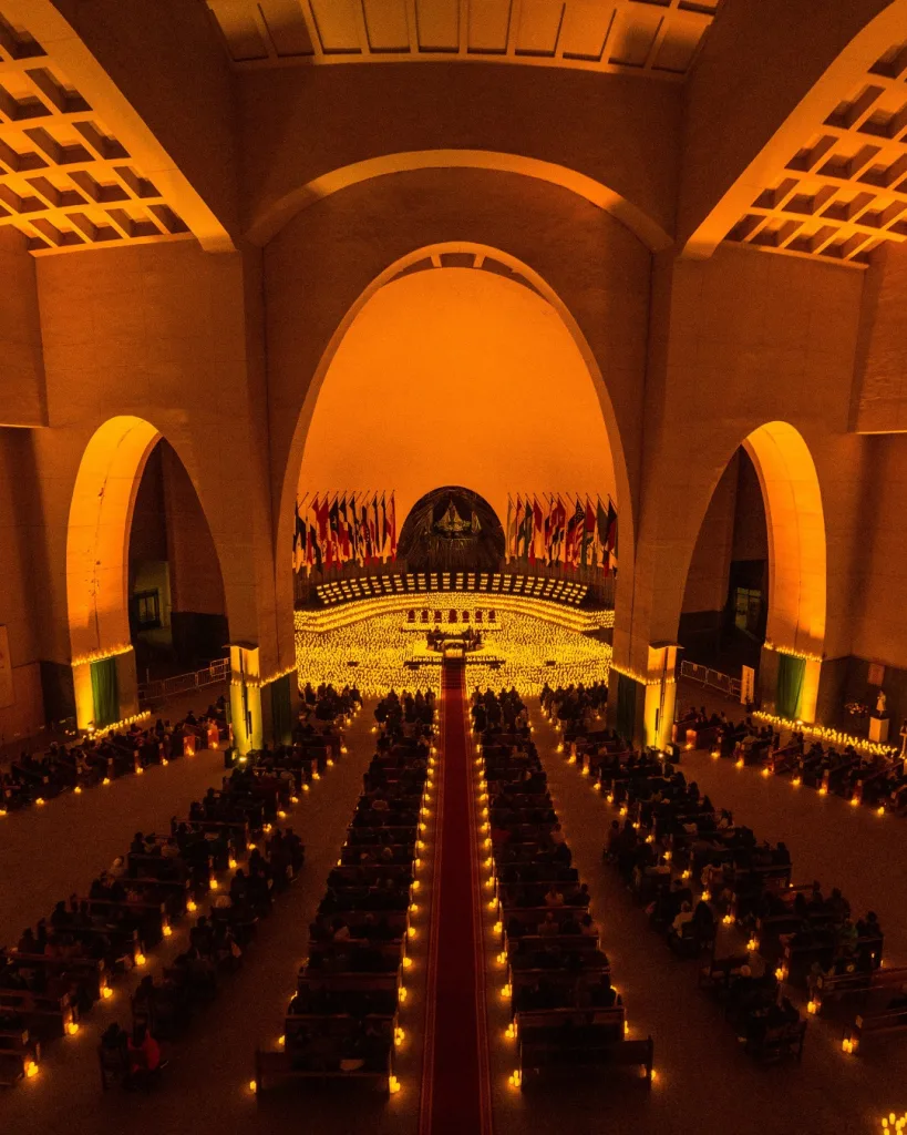 Interior view of a Candlelight concert venue filled with warm candle glow and intimate seating.