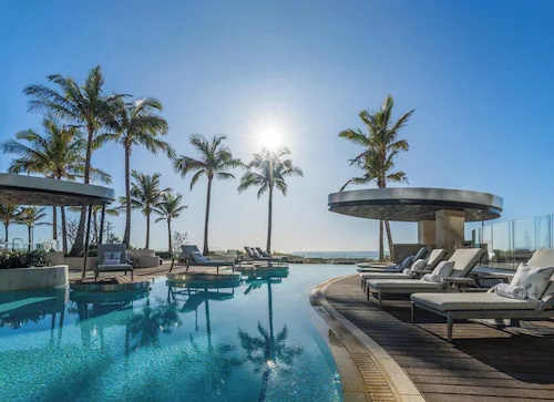 Waterfront view near Kempinski Miami with palm-lined bayfront scenery and a sleek luxury skyline backdrop
