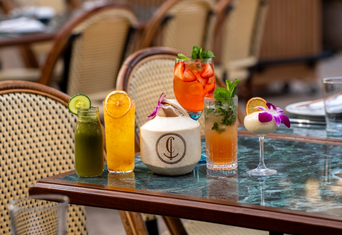 Colorful craft cocktails served on a table during happy hour at a stylish Miami Beach bar