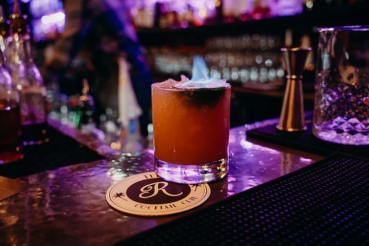 Craft cocktail served at The Regent Cocktail Club bar in Miami Beach during happy hour