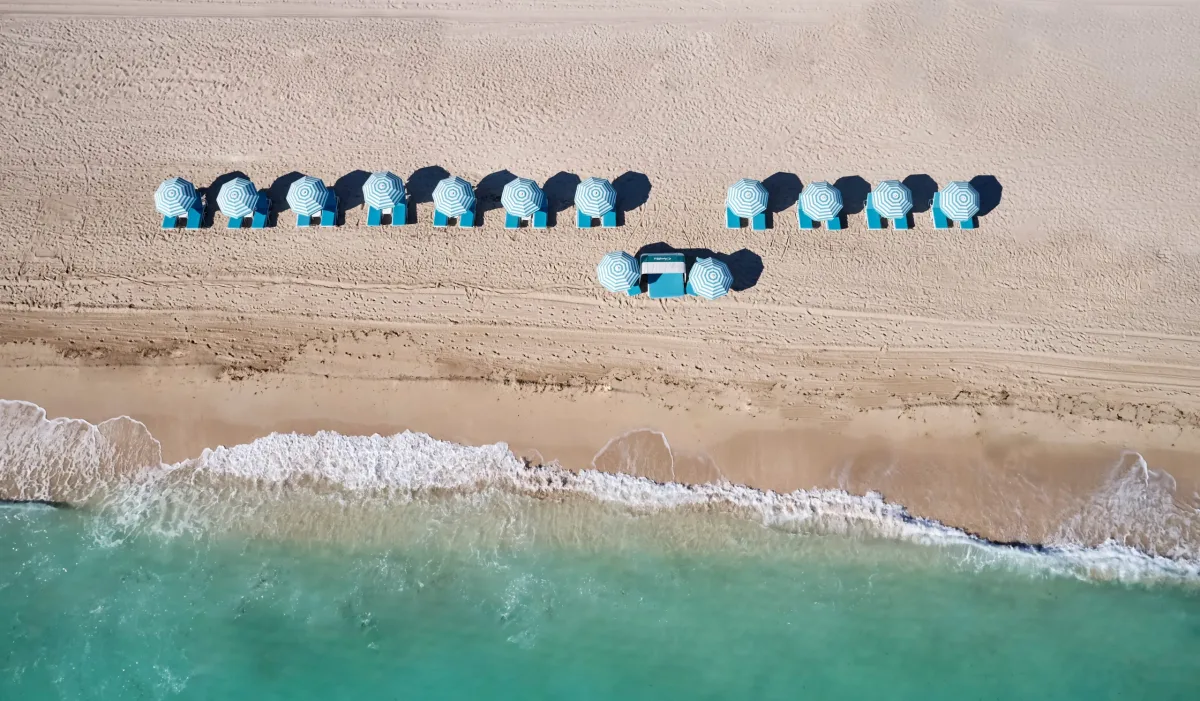 Aerial view of Miami Beach umbrellas and clear water Aerial view of Miami Beach umbrellas and clear blue water