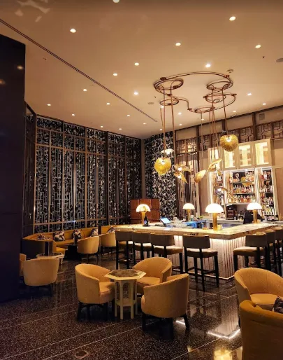Chic bar area at Lapidus Bar with warm lighting, modern decor, and a classic Miami vibe