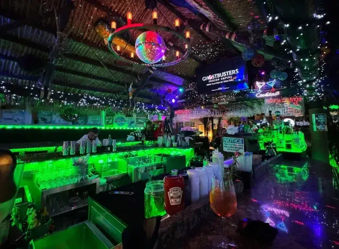 Rakija Lounge bar at night with glowing lights, cocktails, and a lively evening ambiance