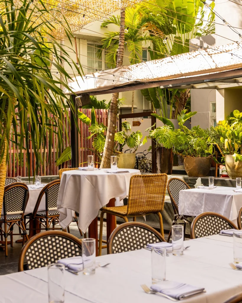 Outdoor patio at Orange Blossom Miami Beach with lush greenery and stylish brunch seating