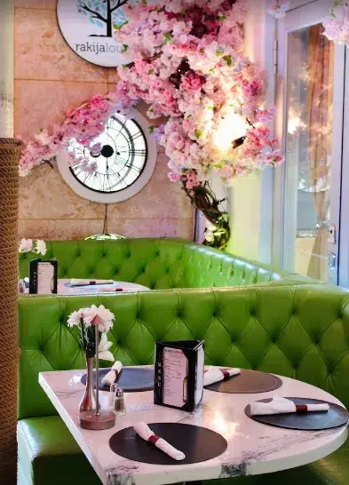 Cozy restaurant interior at Rakija Lounge with inviting tables and a warm Mediterranean atmosphere
