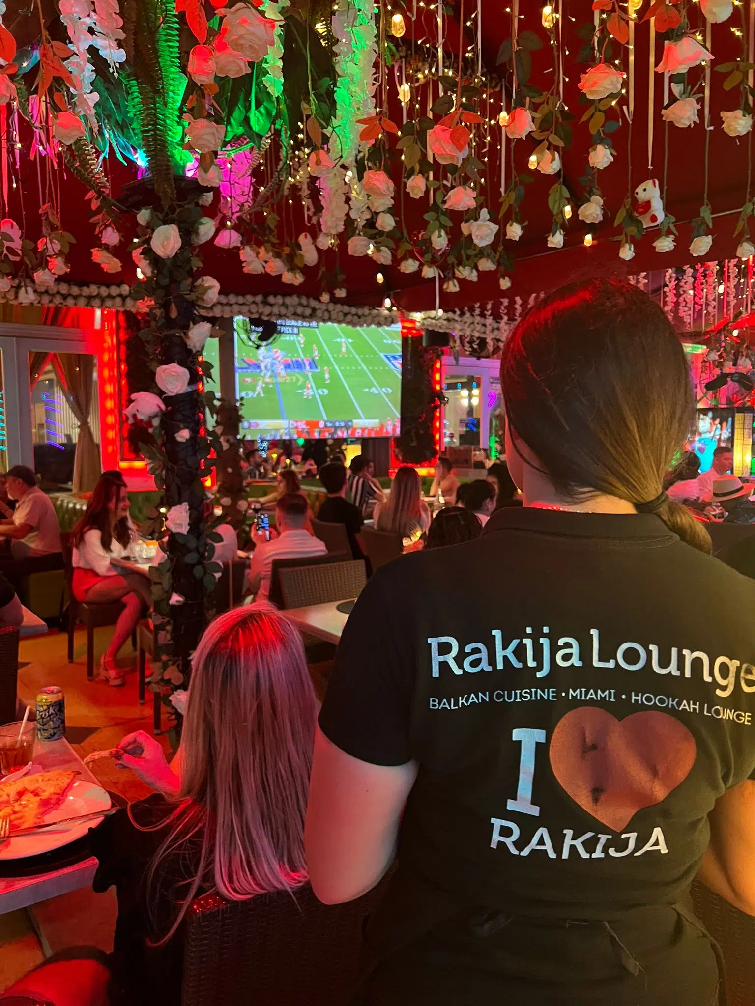 Rakija Lounge Miami Beach interior with guests watching sports and Balkan restaurant atmosphere