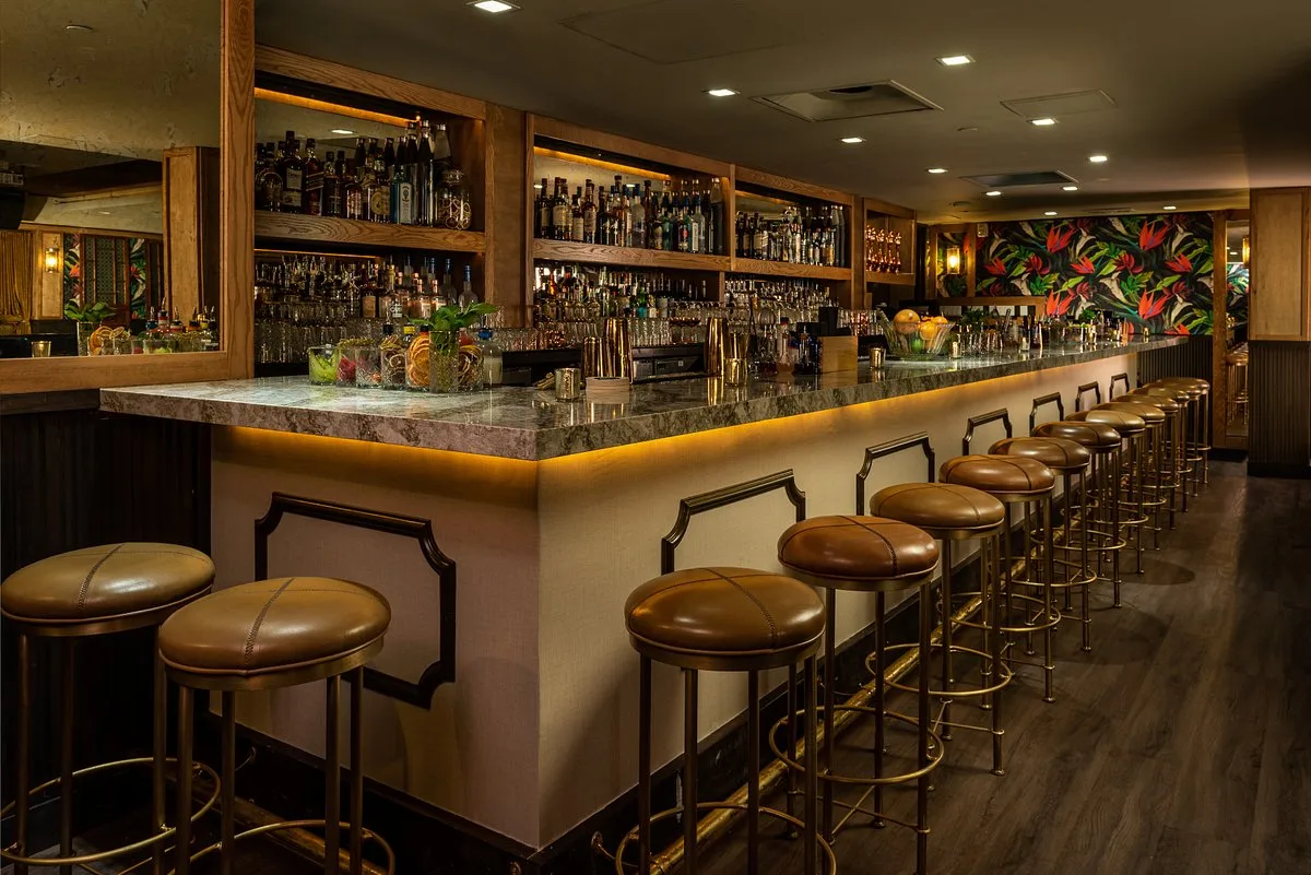 Elegant interior bar of The Regent Cocktail Club in Miami Beach with stools and cocktail lounge atmosphere