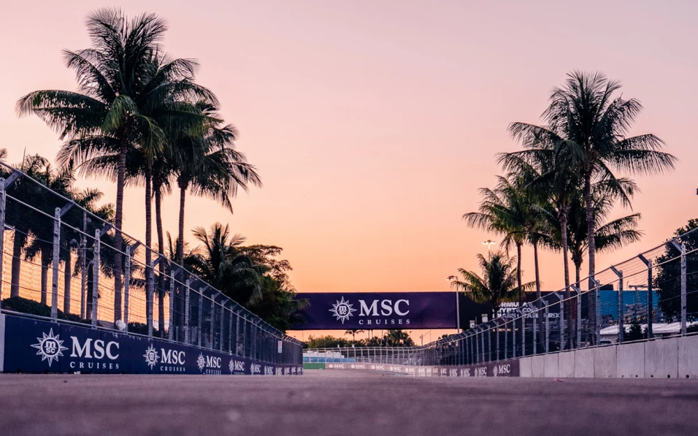Miami Grand Prix race track at sunset with palm trees and Formula 1 circuit barriers
