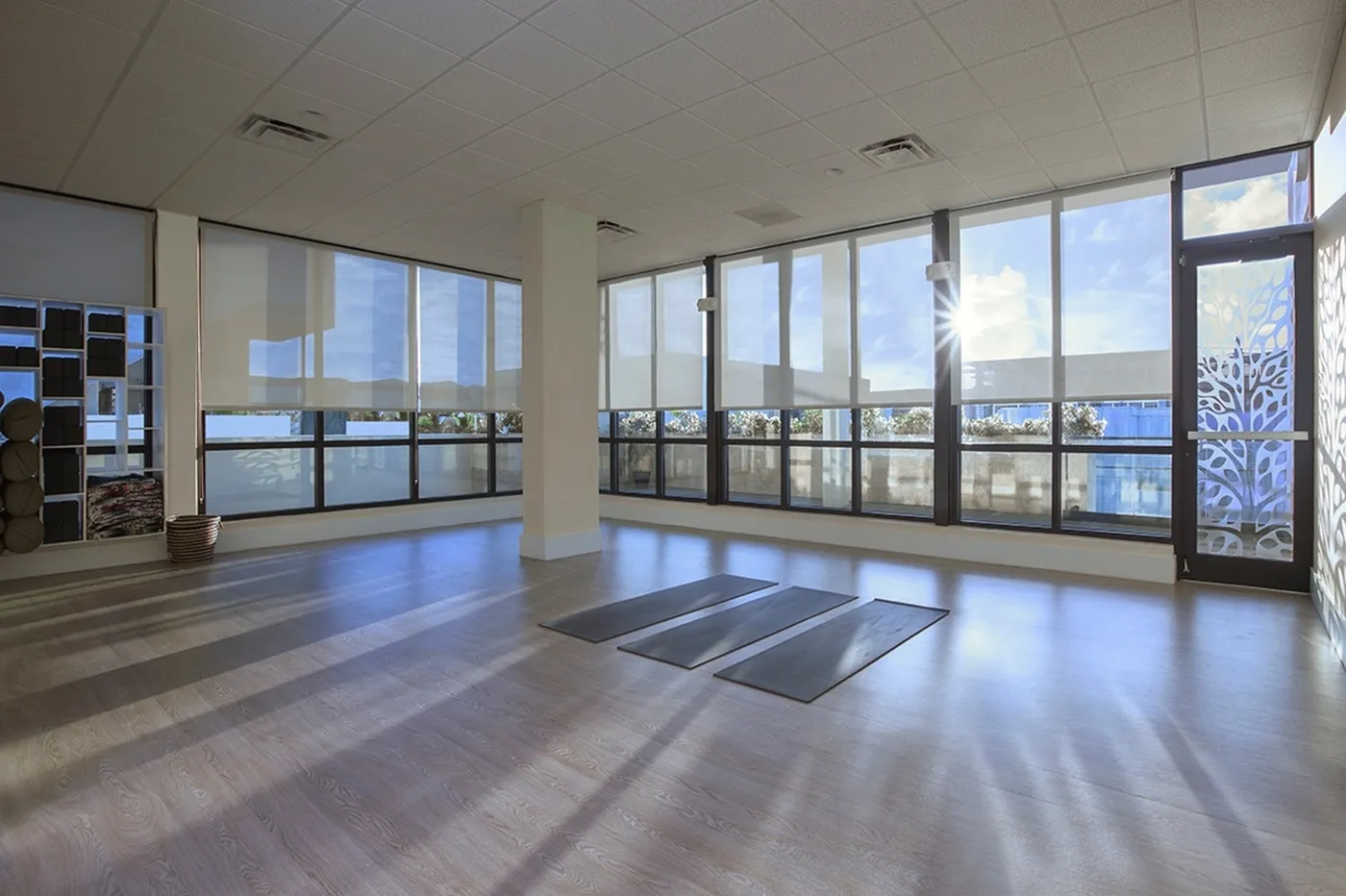 Bright yoga studio with large windows and mats prepared for class in Miami Beach