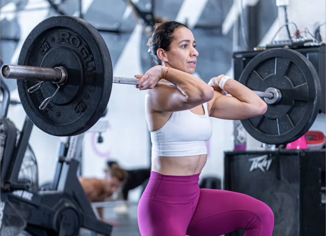 Athlete performing Olympic weightlifting exercise during CrossFit workout in Miami Beach gym