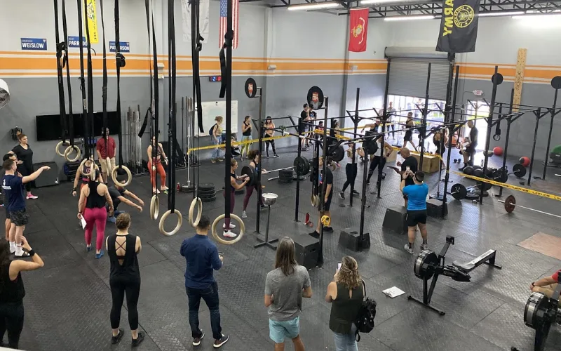 Group CrossFit training session with athletes performing functional fitness exercises in Miami Beach