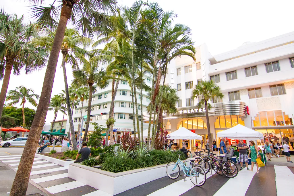 Lincoln Road in Miami Beach with shops, restaurants, and people walking.