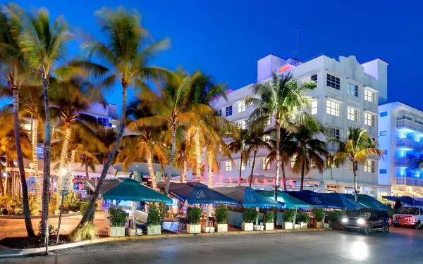Ocean Drive at night with neon lights, restaurants, and lively Miami Beach energy.