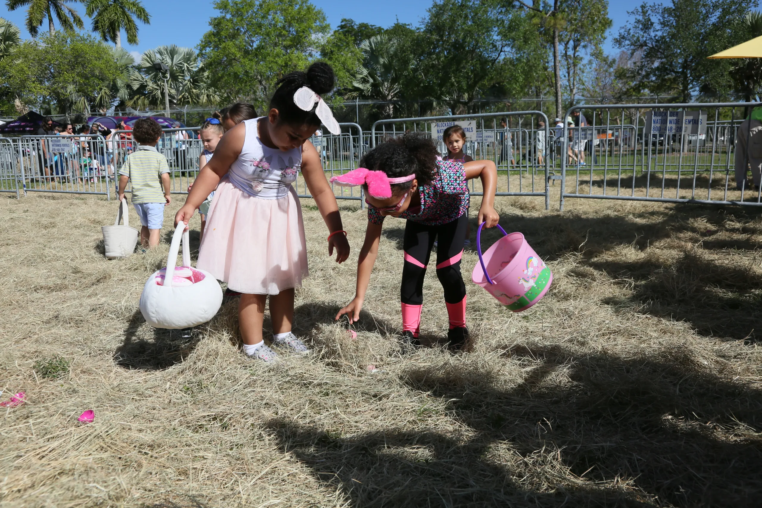 Children participating in an Easter egg hunt at a family-friendly Easter festival in Miami