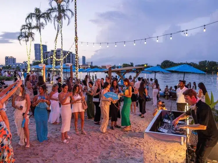 Beach party scene in Miami Beach with people enjoying the oceanfront atmosphere