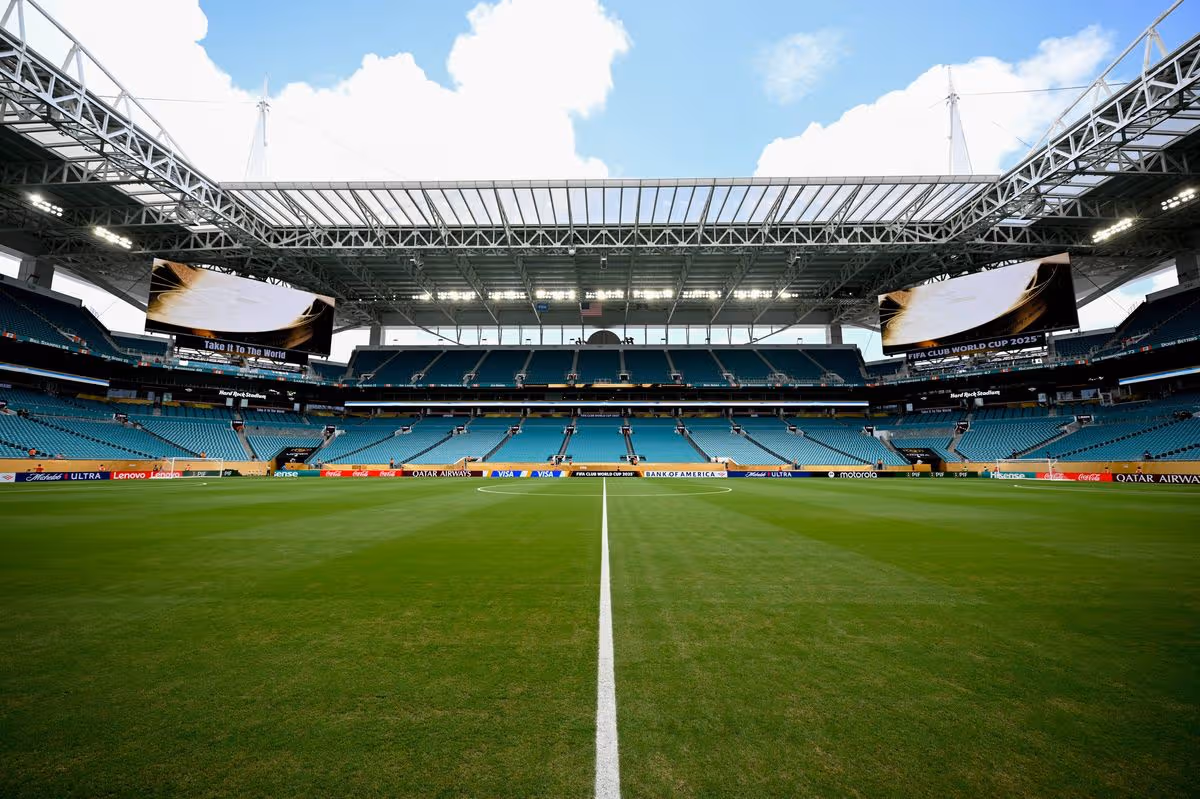Interior view of Hard Rock Stadium in Miami prepared for FIFA World Cup 2026 with a full soccer field and empty seating sections.