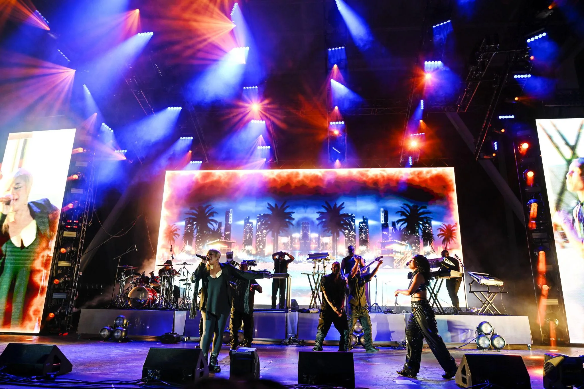 Live music concert performance with colorful stage lights and band playing on stage at a Miami event