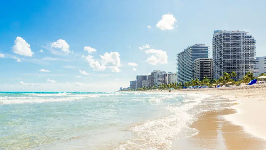 South Beach shoreline in Miami Beach with ocean, sand, and Art Deco hotels nearby