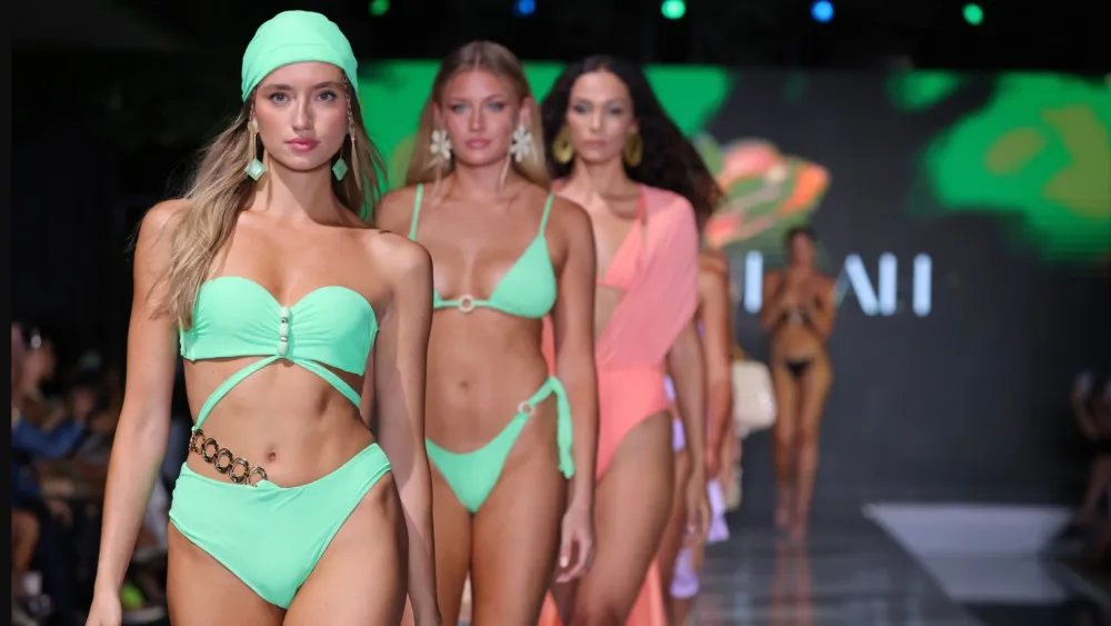 Runway models showcasing designer swimwear during Miami Swim Week in South Beach.