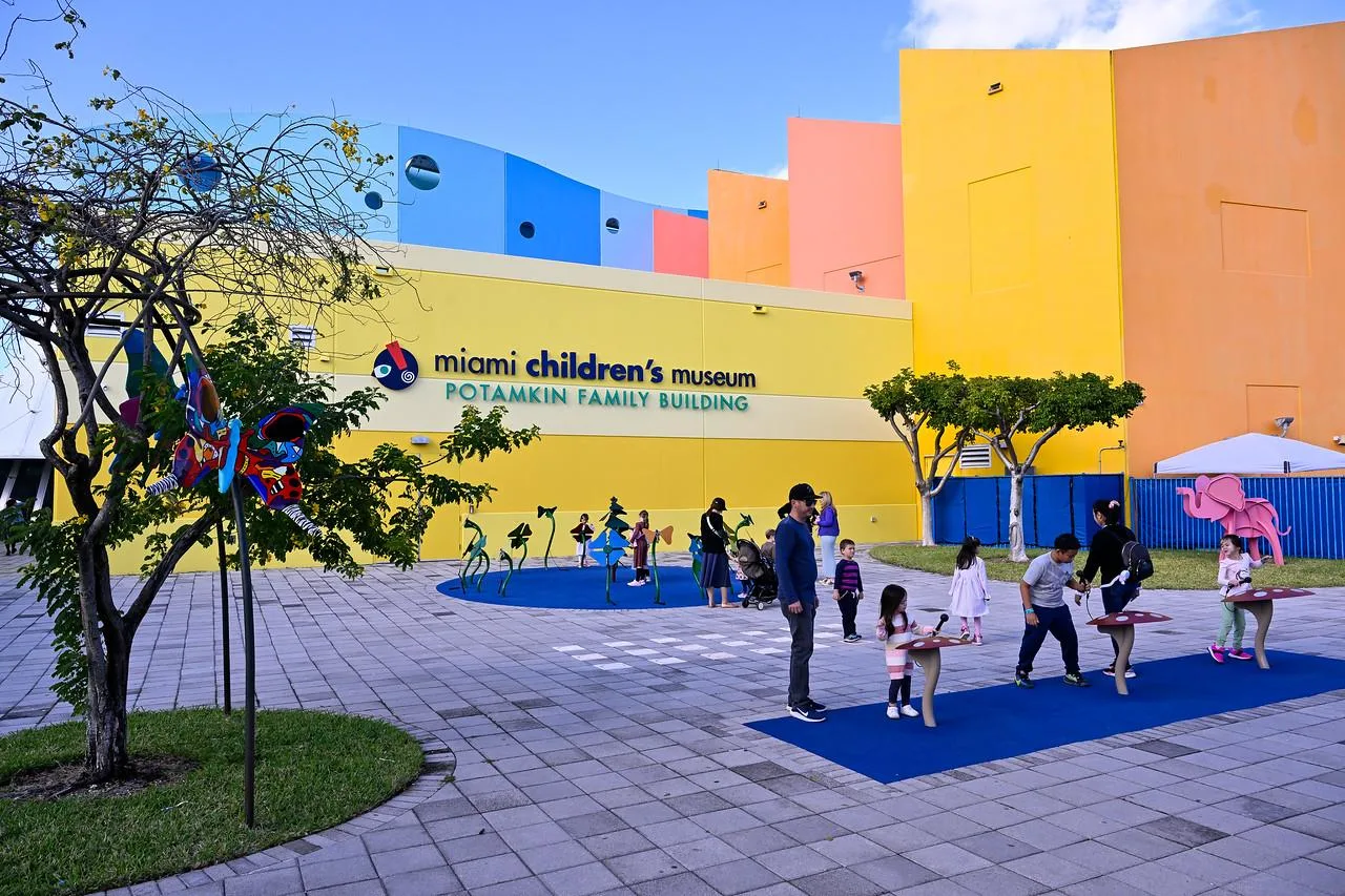 Families and children playing outside Miami Children’s Museum colorful building on a sunny day in Miami