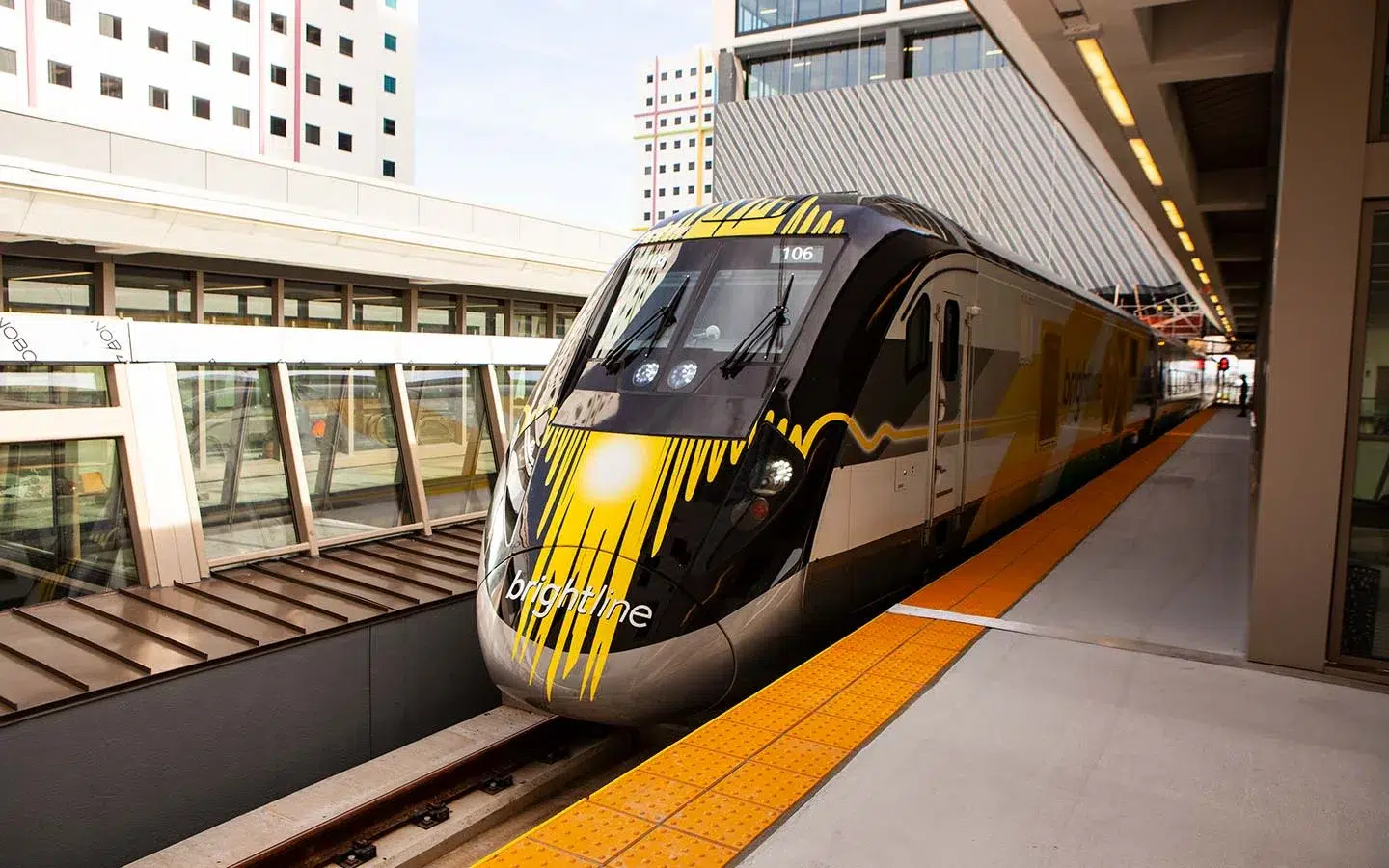 Brightline high-speed train arriving at a Miami station that will connect soccer fans to FIFA World Cup 2026 stadium shuttle services.