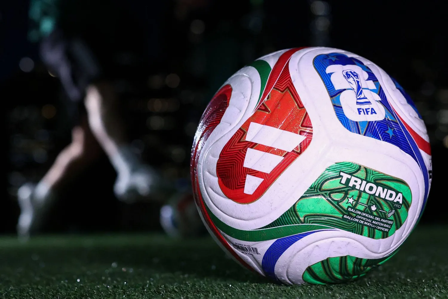 Official FIFA World Cup soccer ball displayed on a football field, symbolizing the excitement and global competition of the FIFA World Cup tournament.