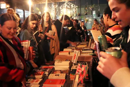 Visitors browsing books and literature displays during a Juneteenth community book fair in Miami, highlighting local authors, cultural storytelling, and educational programming.