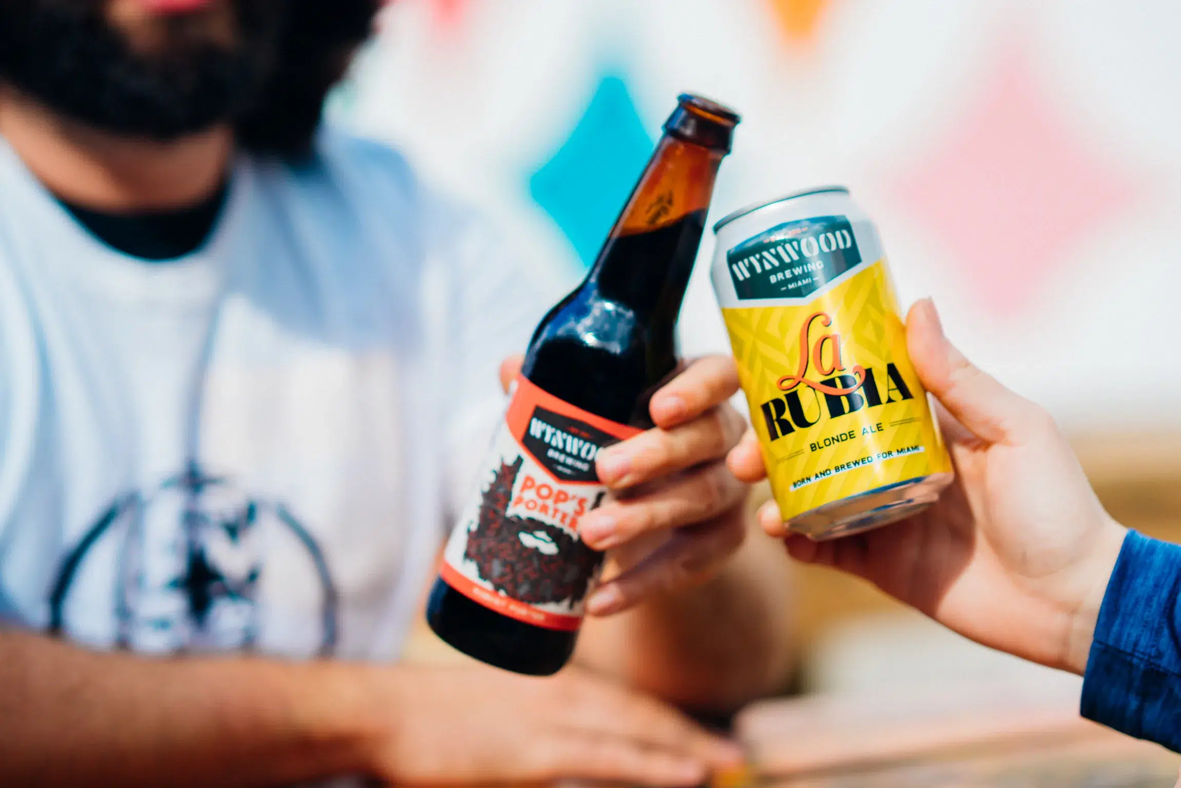 Friends enjoying craft beer at a Miami brewery, highlighting the city's growing craft beer scene and popular Father's Day weekend activities.