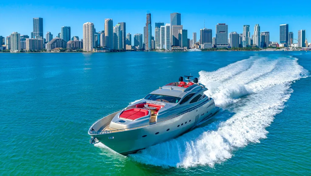 Luxury yacht sailing near Miami Beach with city views in the background.