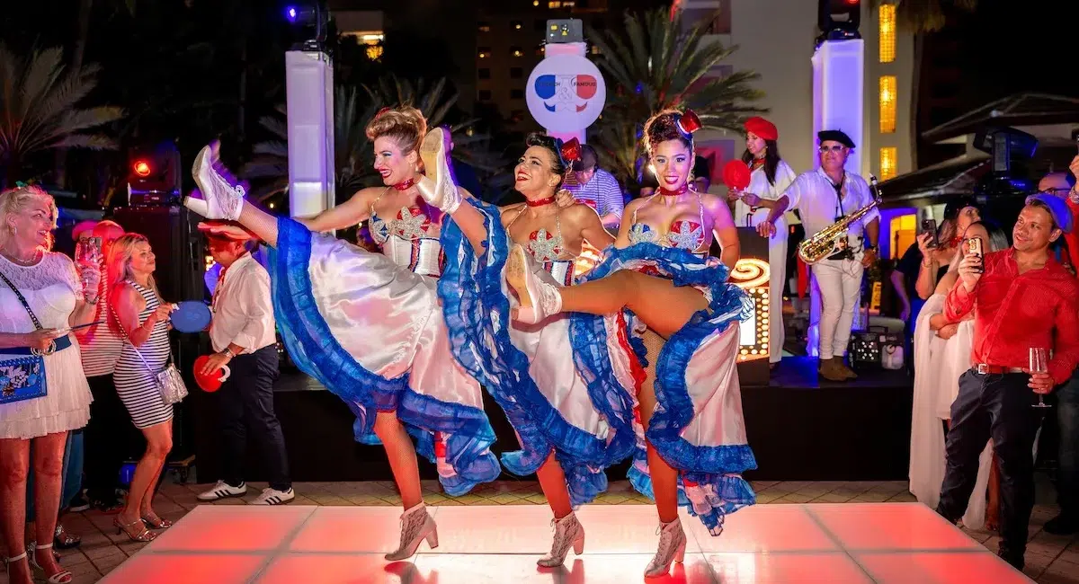 French can-can dancers performing live during a Bastille Day celebration in Miami, featuring traditional costumes, music, and vibrant cultural entertainment.
