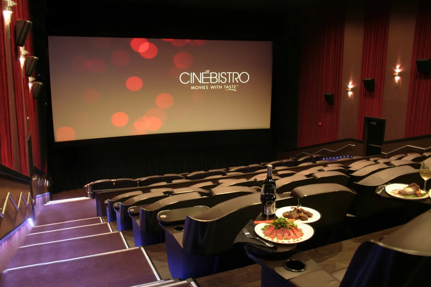 Luxury CinéBistro movie theater in Miami with reclining seats, in-theater dining, and gourmet food, offering a comfortable escape from Miami's summer heat.